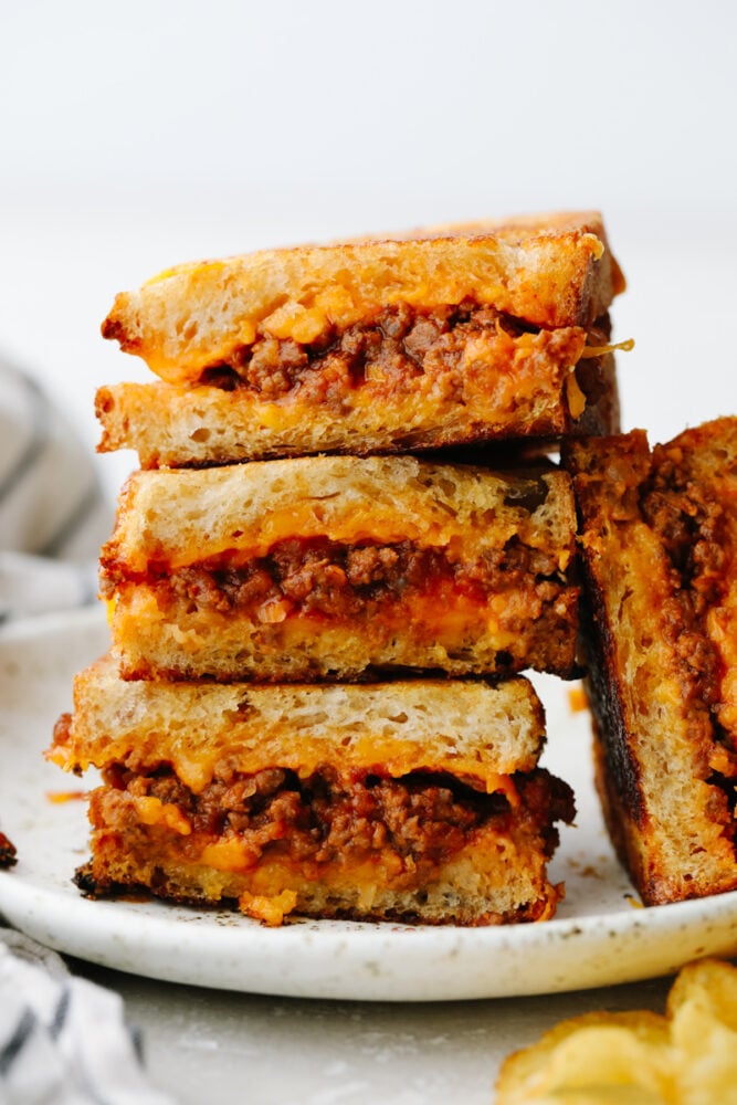 A sliced sloppy joe grilled cheese on a plate. 