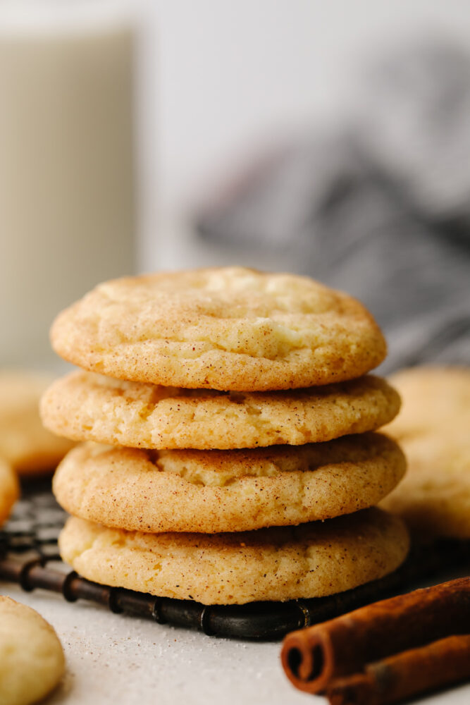 A stack of snickerdoodles on a cooling rack. 