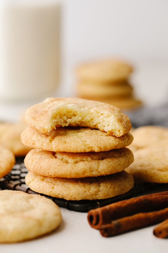 A stack of snickerdoodle cookies with a bite taken out of the top one! 