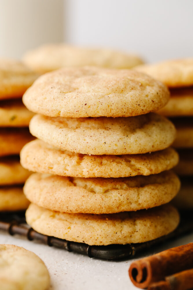 A stack of cookies on a cooling rack. 