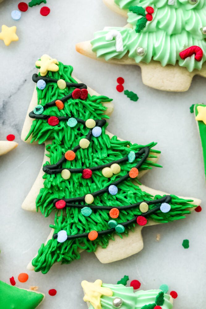 Closeup of a Christmas tree sugar cookie with Christmas light detailing.