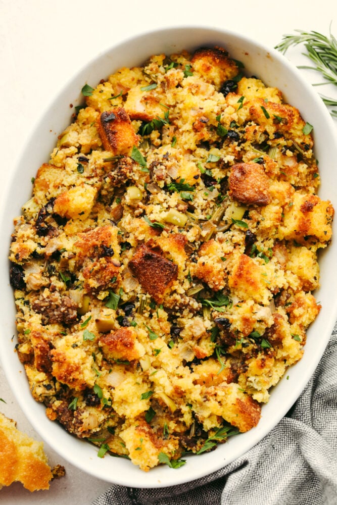 Cornbread stuffing in a white casserole dish.