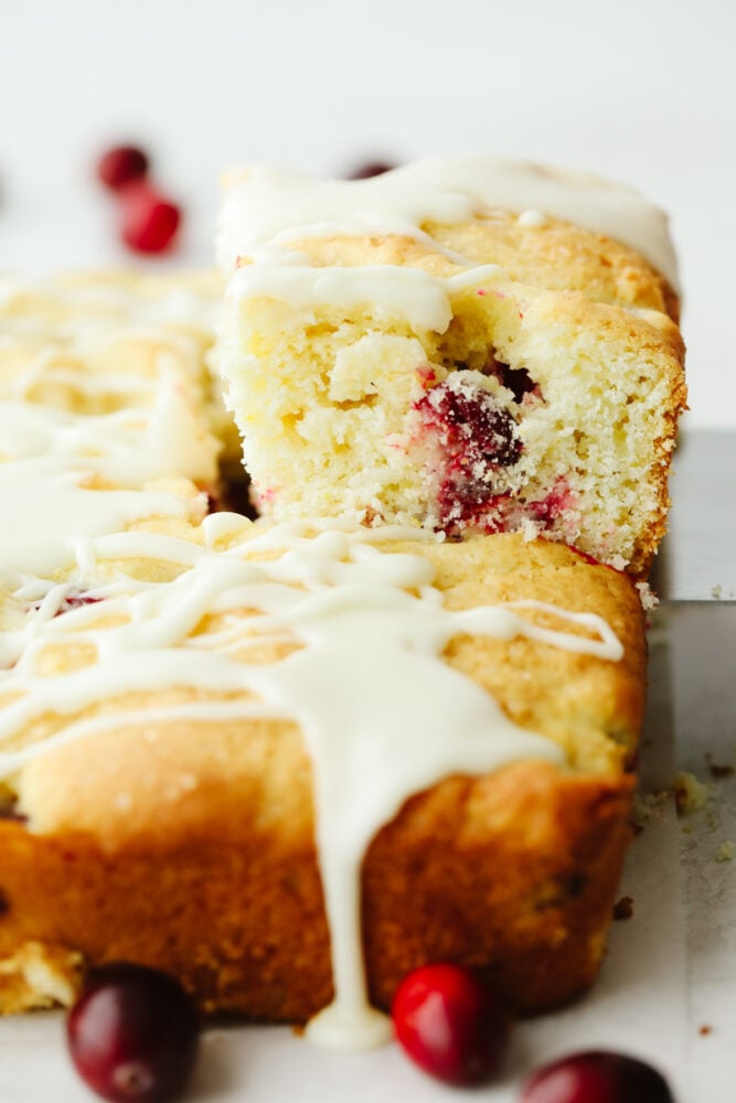 Cranberry cake being sliced. 
