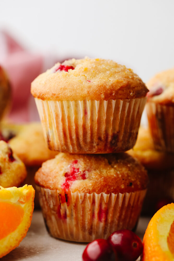 2 cranberry orange muffins stacked on top of each other.