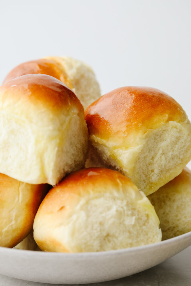 Rolls stacked in a white bowl.