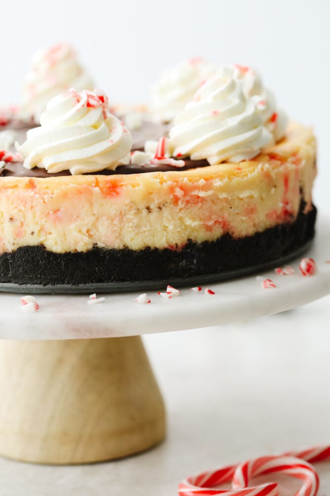 Peppermint cheesecake on a cake stand. 