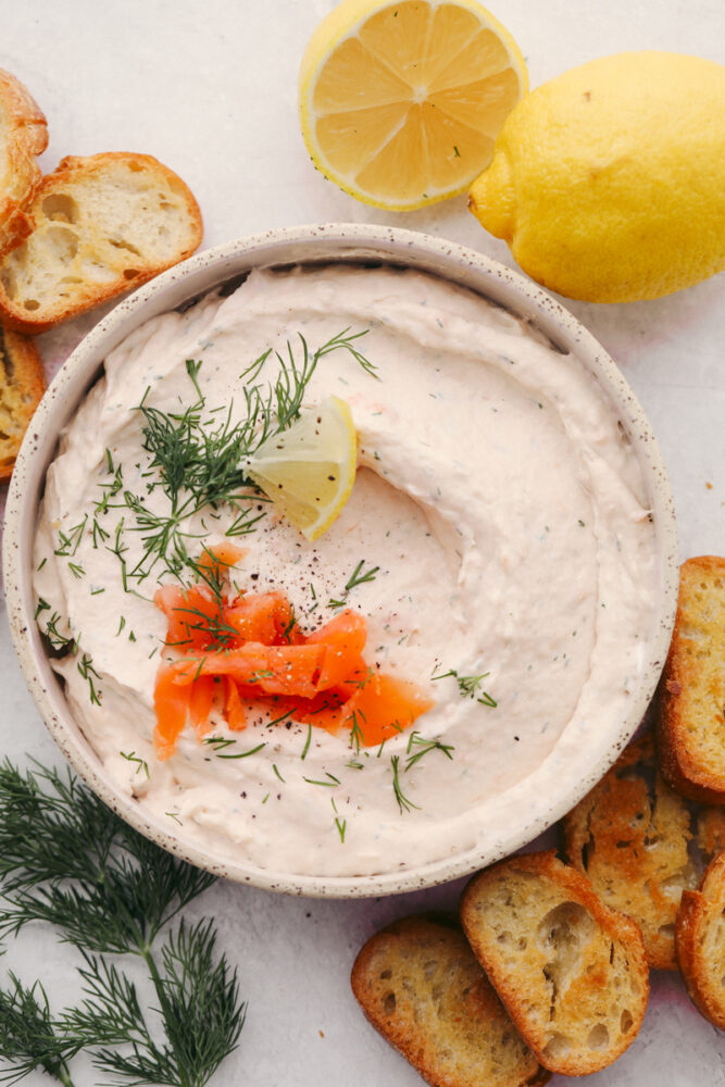 Smoked salmon dip in a bowl with some garnish. 