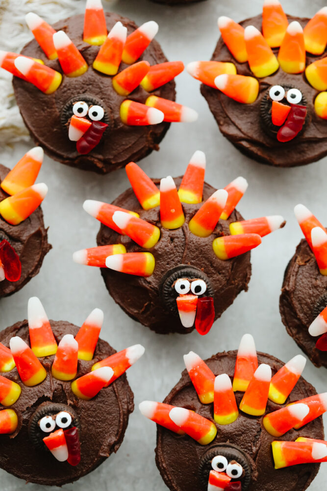 A few turkey cupcakes on the counter. 