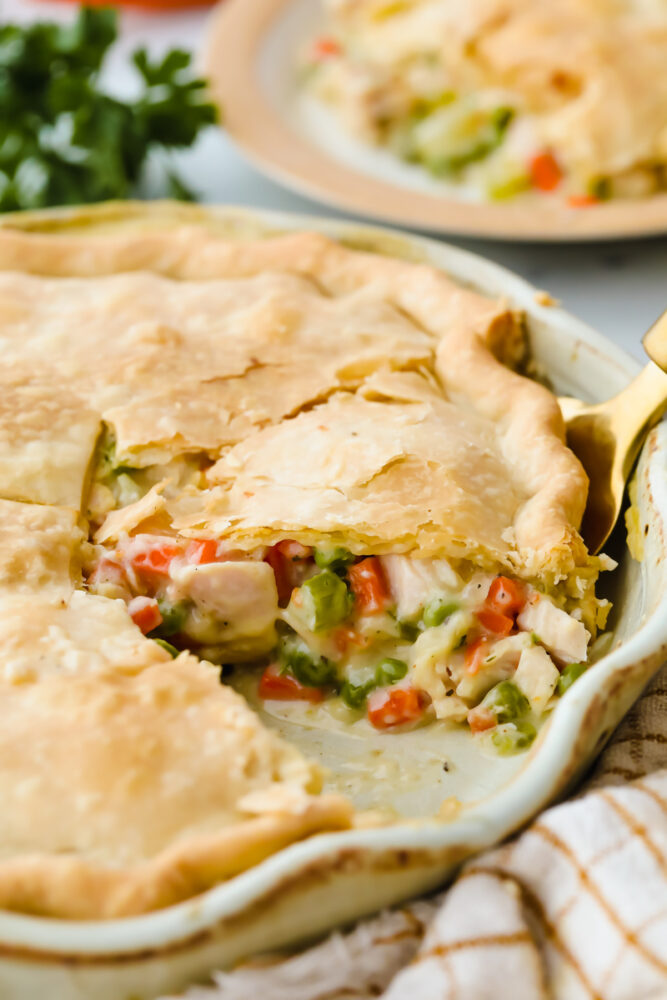A turkey pot pie with a slice cut out of it. 