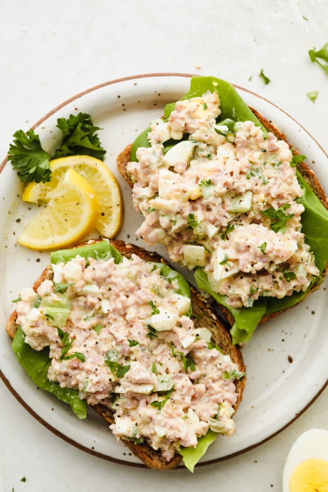 Ham salad on bread with some lettuce. 