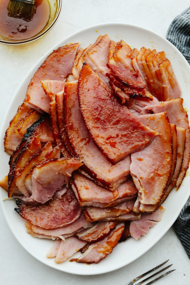 A platter of sliced apricot glazed ham. 