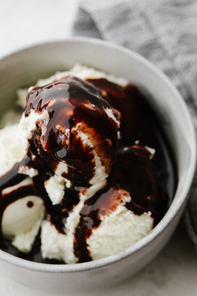 Ice cream in a bowl with chocolate sauce. 