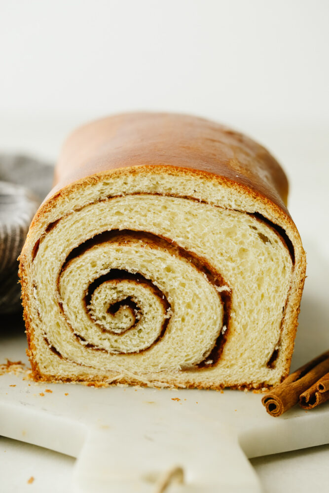 A loaf of cinnamon swirl bread with the inside swirl showing. 