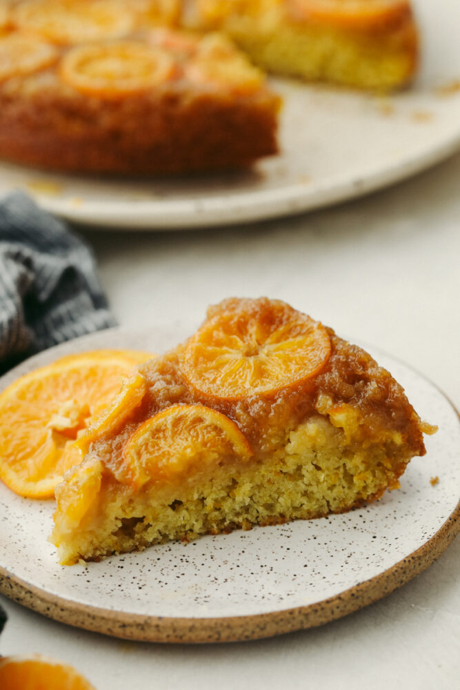 A slice of clementine cake on a white plate.