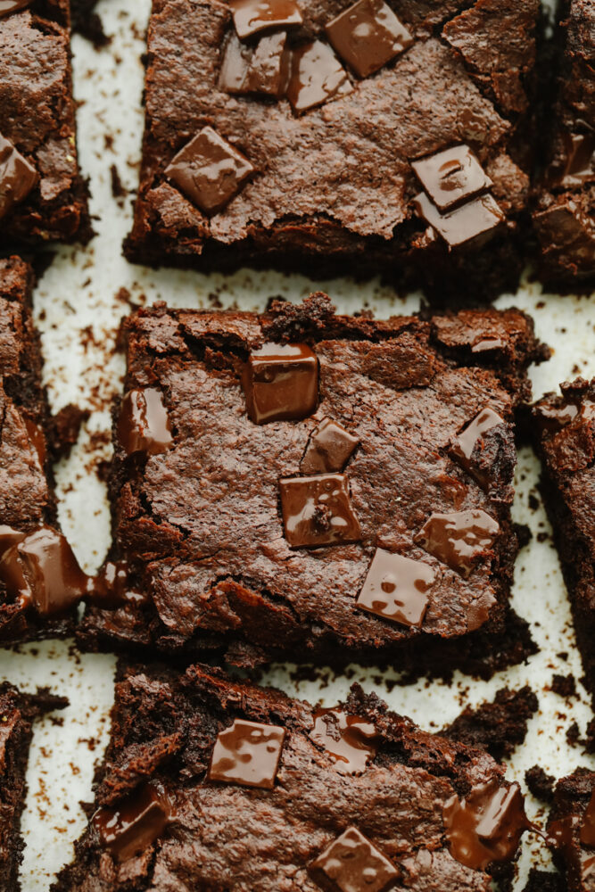 A zoomed in shot of 2 flourless chocolate brownies. 