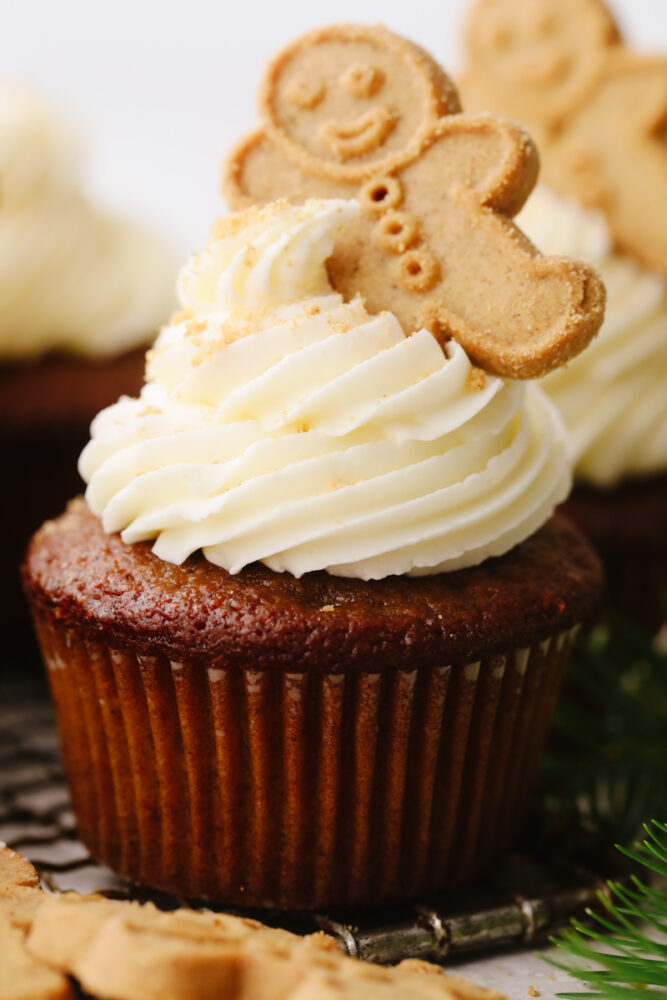 A gingerbread cupcake with white chocolate buttercream frosting on top. 