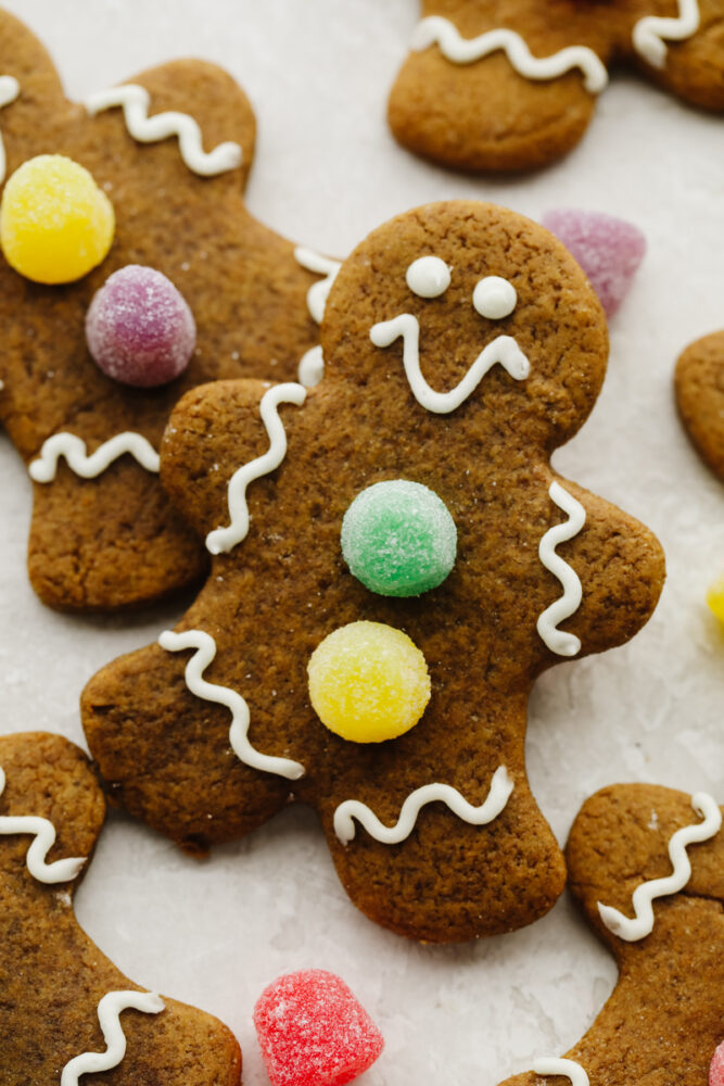 Zoomed in picture of a gingerbread cookies with gumdrops as buttons. 