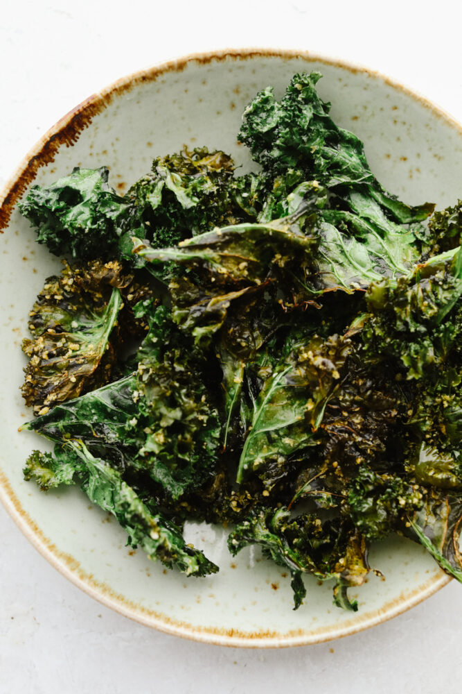 Cooked kale chips on a plate. 
