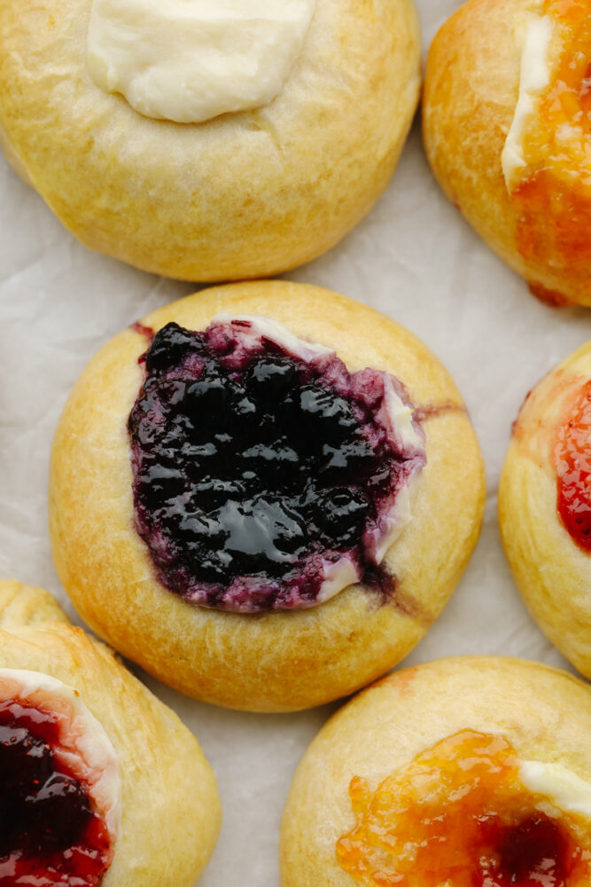 A zoomed in picture of a blueberry, cream cheese kolache. 