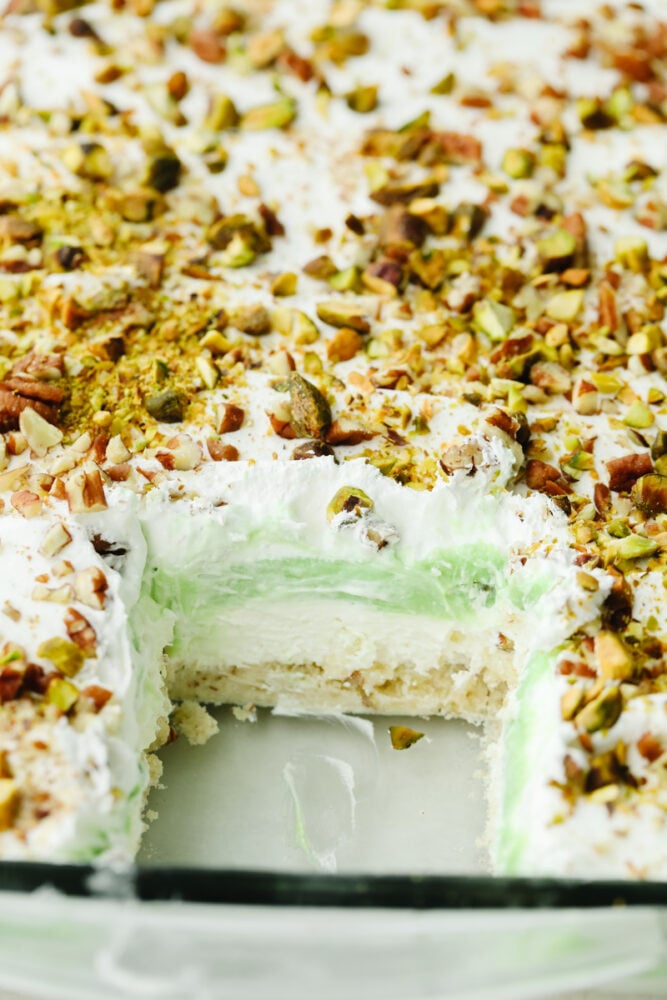 A view of all of the layers of a pistachio dessert.