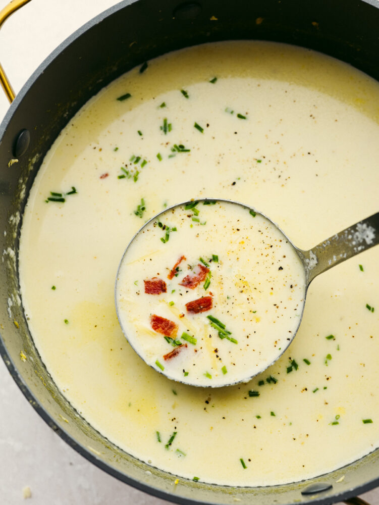 Cauliflower soup in a pot with a ladle. 