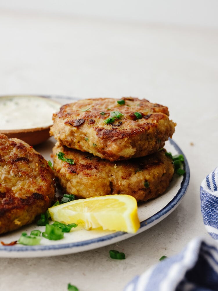 A stack of chicken patties on a plate. 