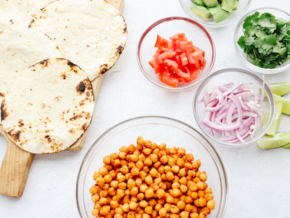 Small tortillas and various vegetable toppings.