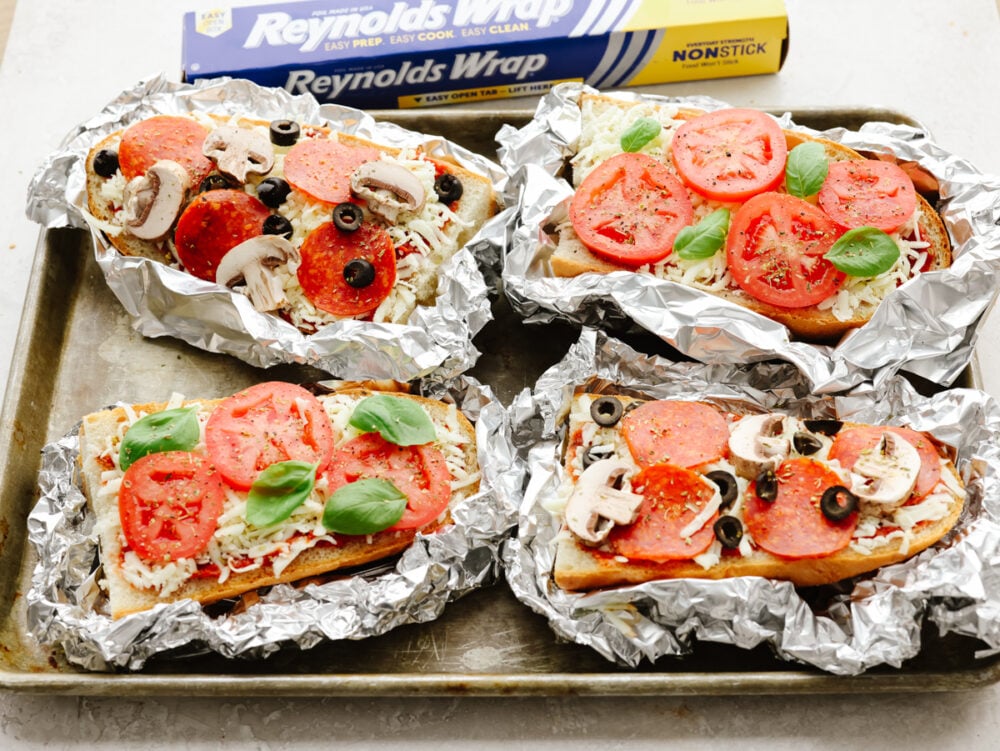 Foil french bread pizzas cooked and ready to eat. 