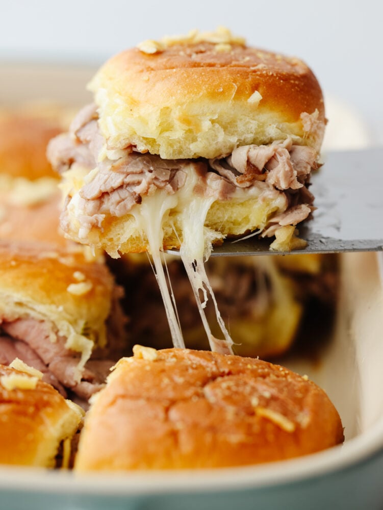 A French dip slider being taken out of the pan.