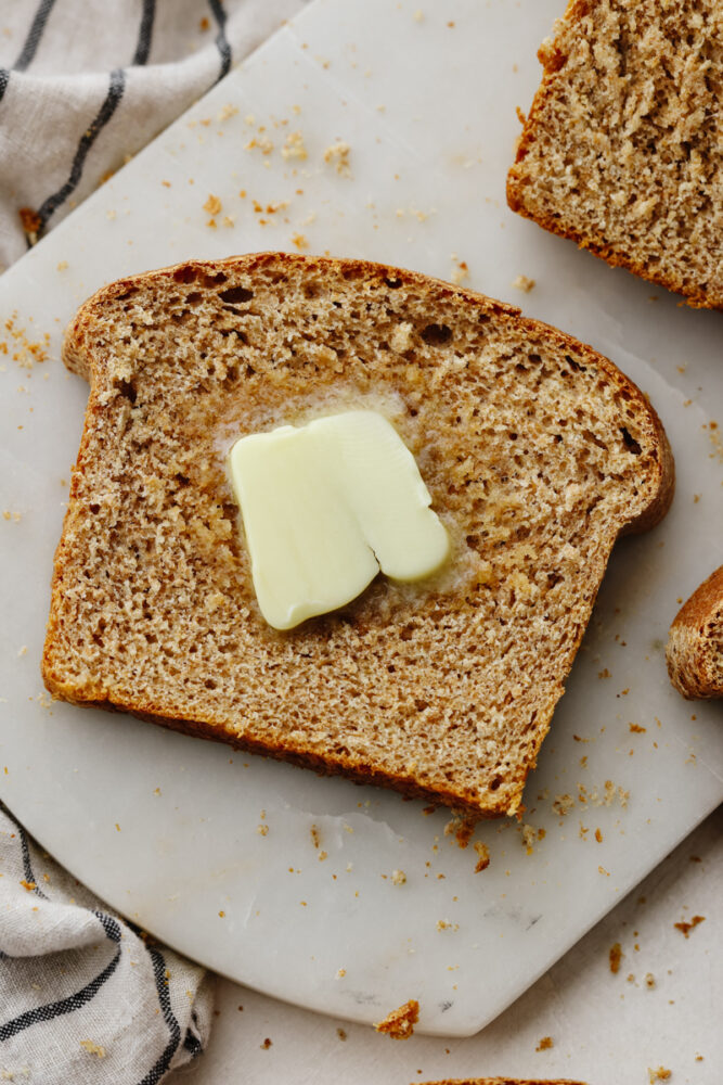 A slice of bread with butter on it.
