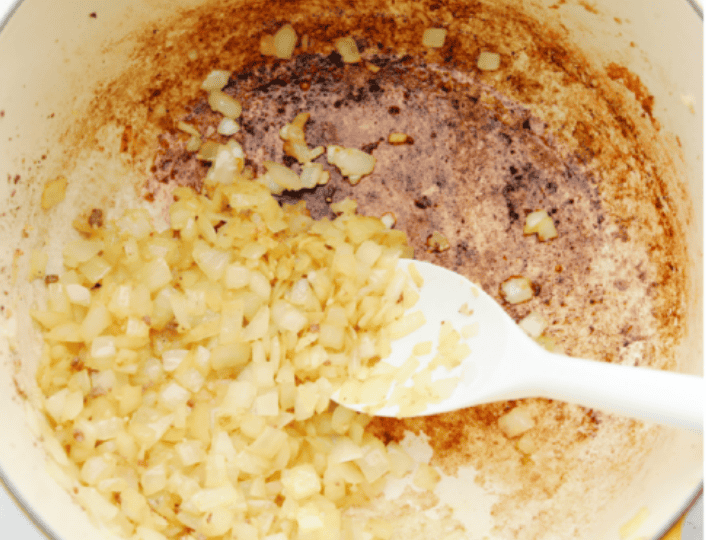 American Goulash is my kind of comfort food! It's rich, savory, and full of that cozy, tomato-y goodness. It’s hearty, easy to make, and one bite will have you hooked just like my family is! Onions cooking with garlic in the pot
