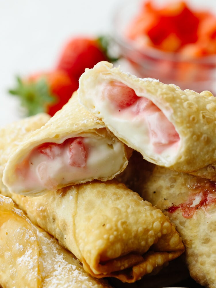 A zoomed in picture of a cheesecake egg roll that is cut in half. 