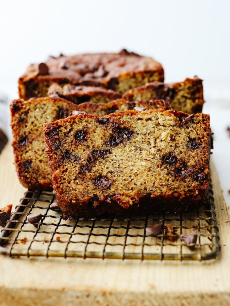 Sliced chocolate chip banana bread on a cooling rack. 