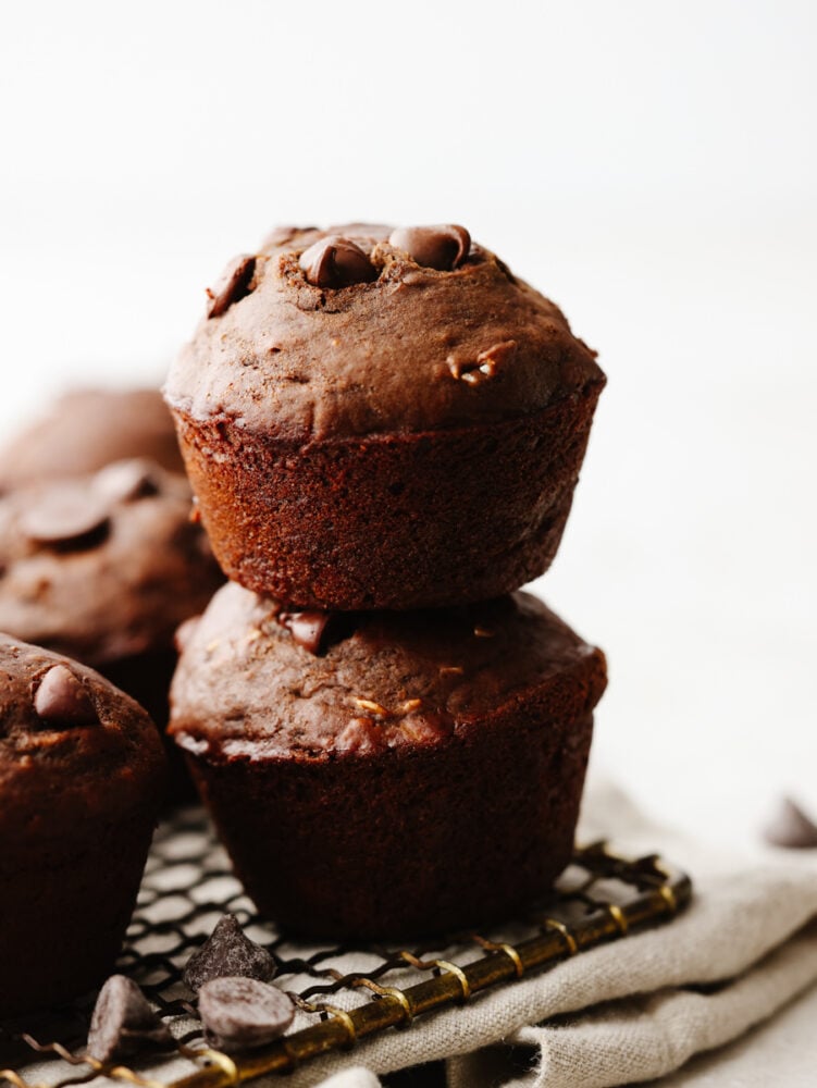 A stack of double chocolate muffins on a baking sheet. 
