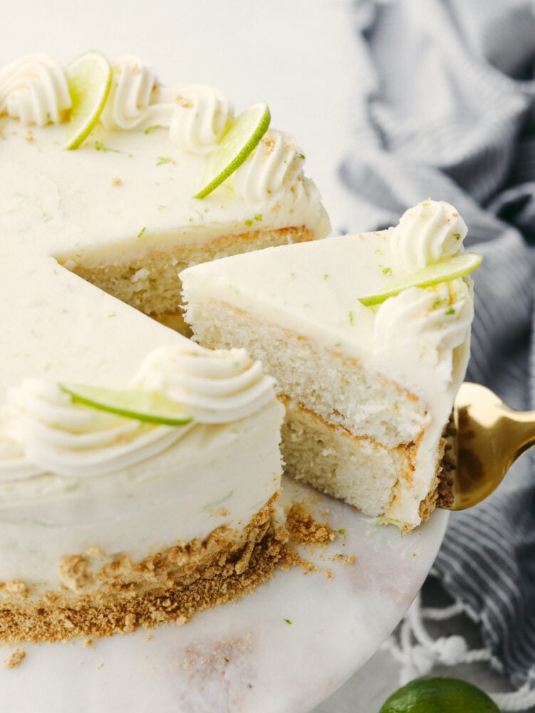 Taking a slice of key lime cake with a cake server.