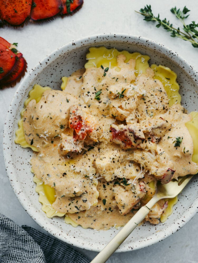 Lobster ravioli in a gray stoneware plate.