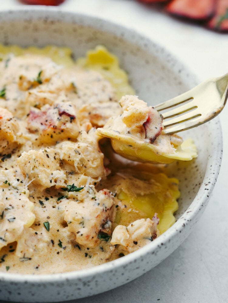 Picking up lobster and ravioli with a fork.