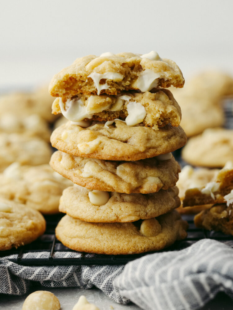 A stack of macadamia nut cookies on a cooling rack. 