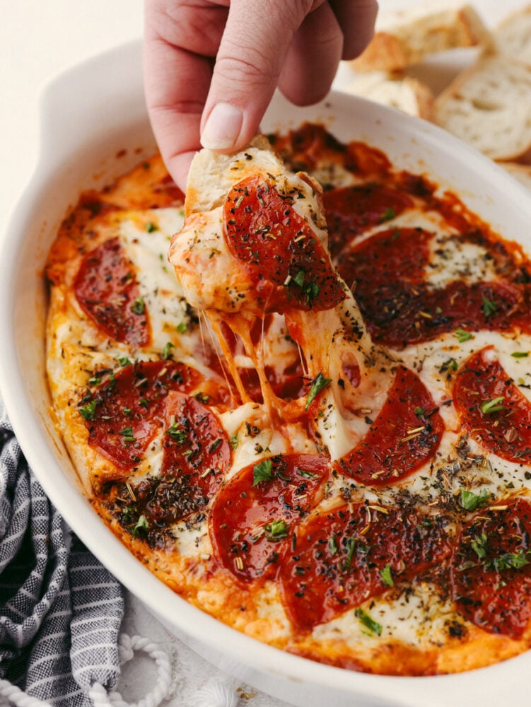 A dish filled with pepperoni pizza dip. 