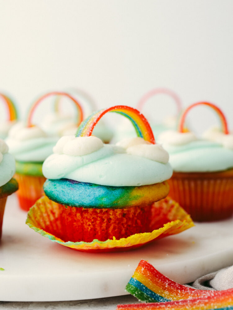 Rainbow cupcakes on a marble serving platter.
