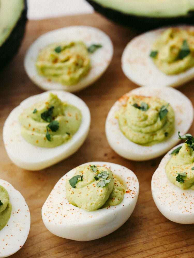 Closeup of avocado deviled eggs dusted with paprika.
