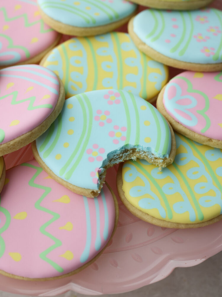 Closeup of an Easter egg cookie with a bite taken out of it.