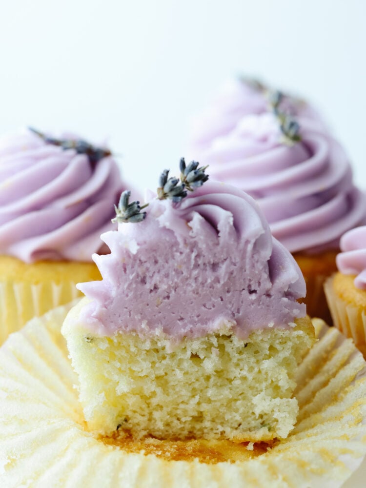 A lavender cupcake cut in half. 