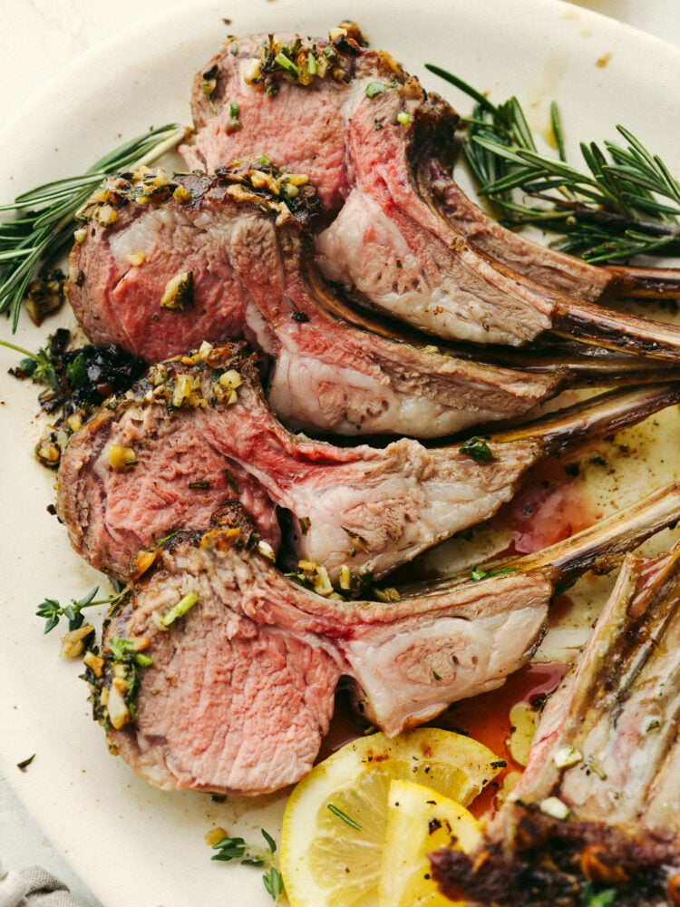 A plate with 4 pieces of the rack of lamb.