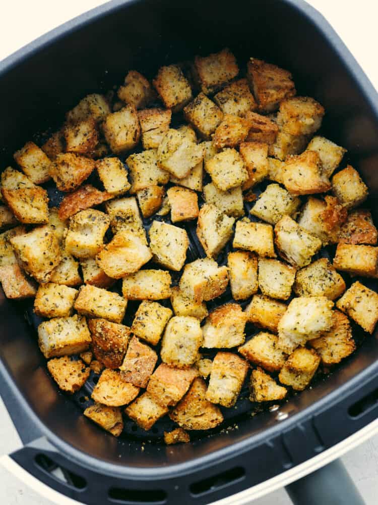Hero image of croutons in the basket of an air fryer.