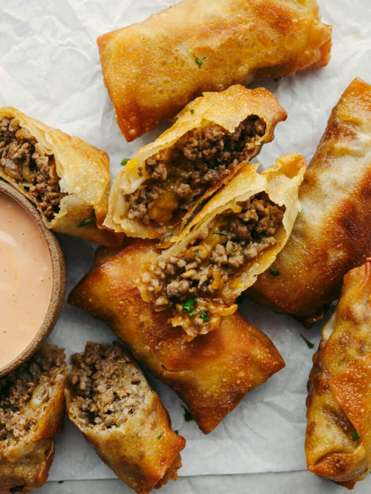 Top-down view of eggrolls cut into halves so the filling can be seen.