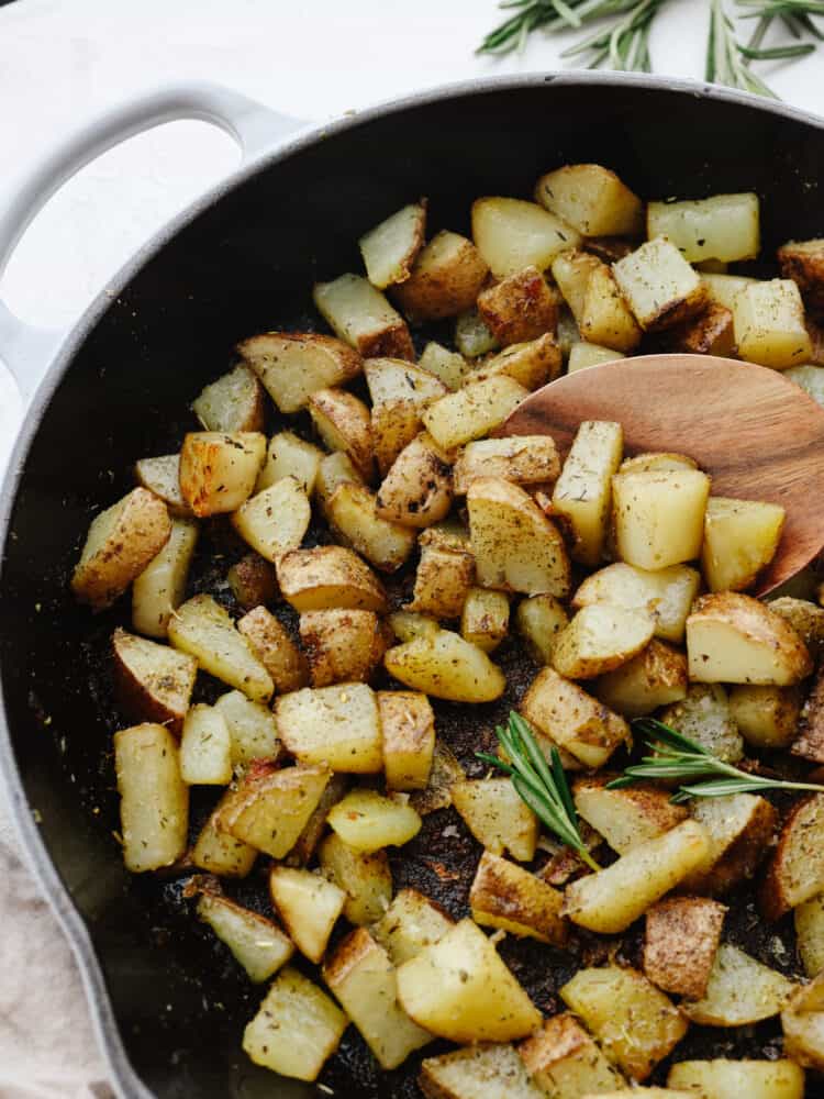 Closeup of pan fried potatoes in a skillet.