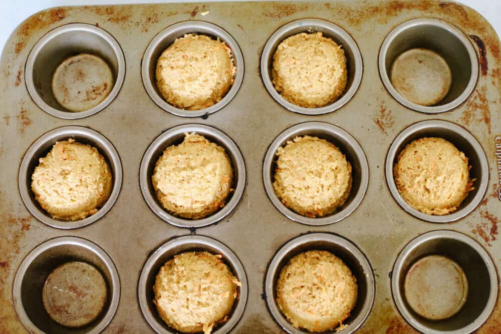 Top-down view of pupcake batter in a muffin tin.