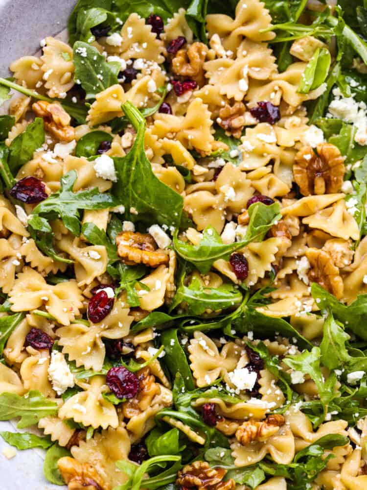 Closeup of cranberry feta bowtie salad with spinach.