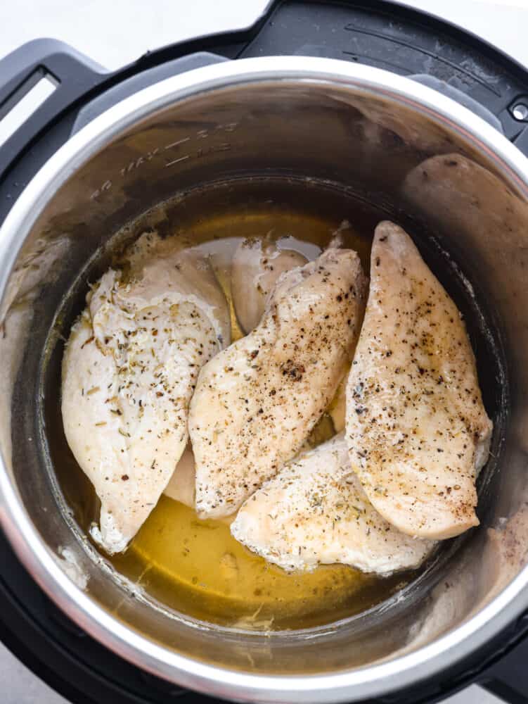 The top view of seasoned. frozen chicken breasts in an instant pot.
